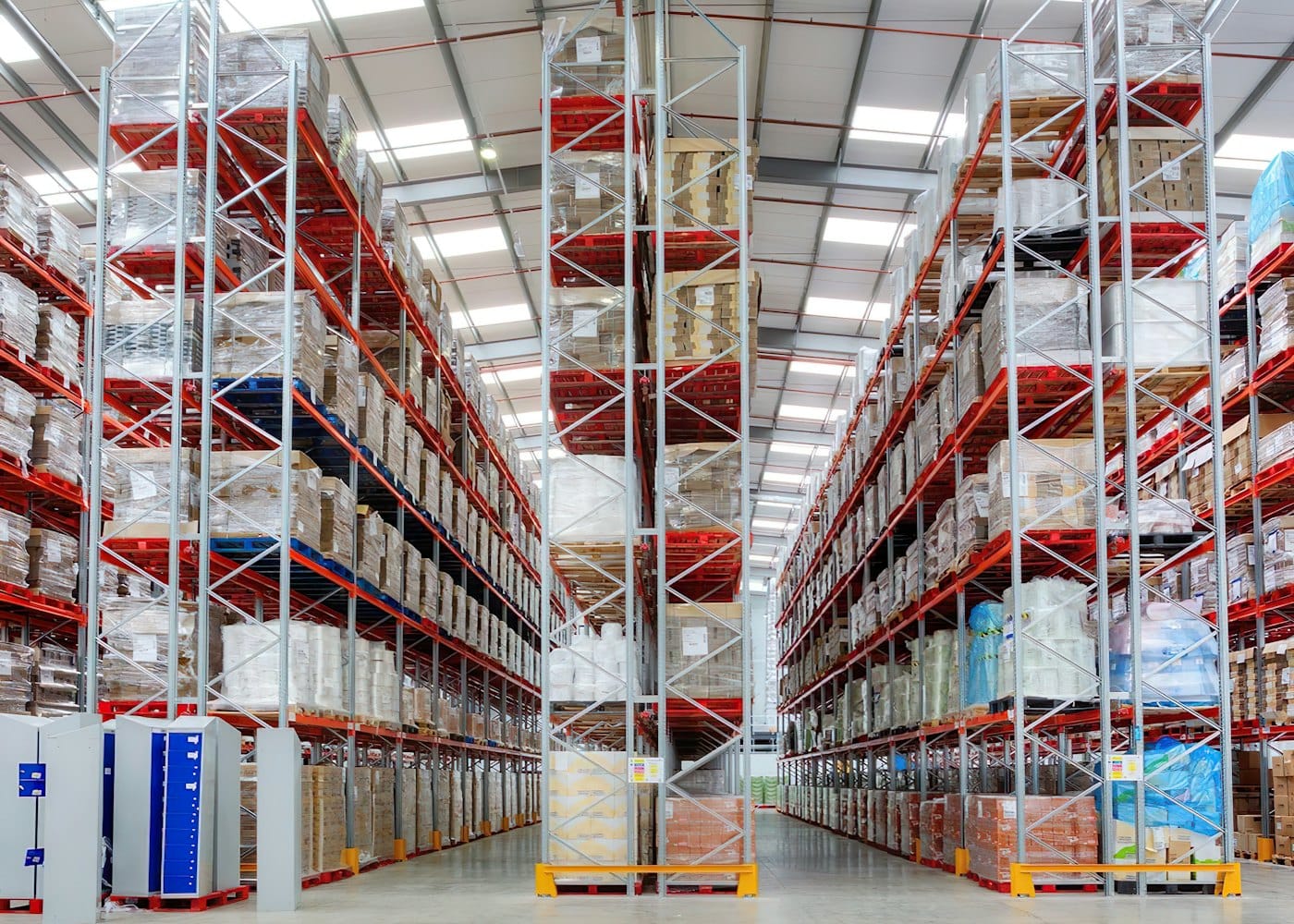 Wide warehouse aisle with pallets on tall racking