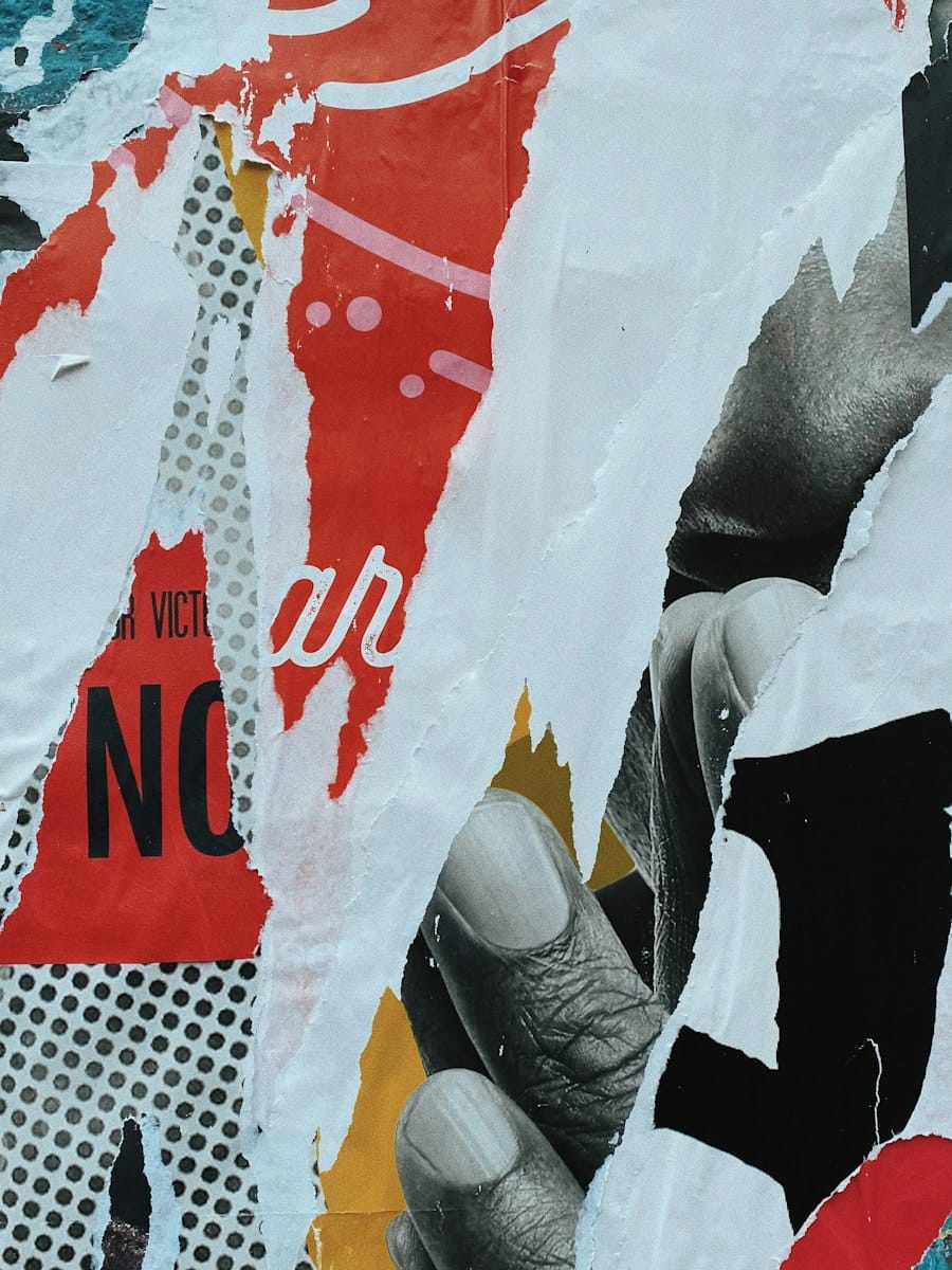 Layers of torn red and white street posters