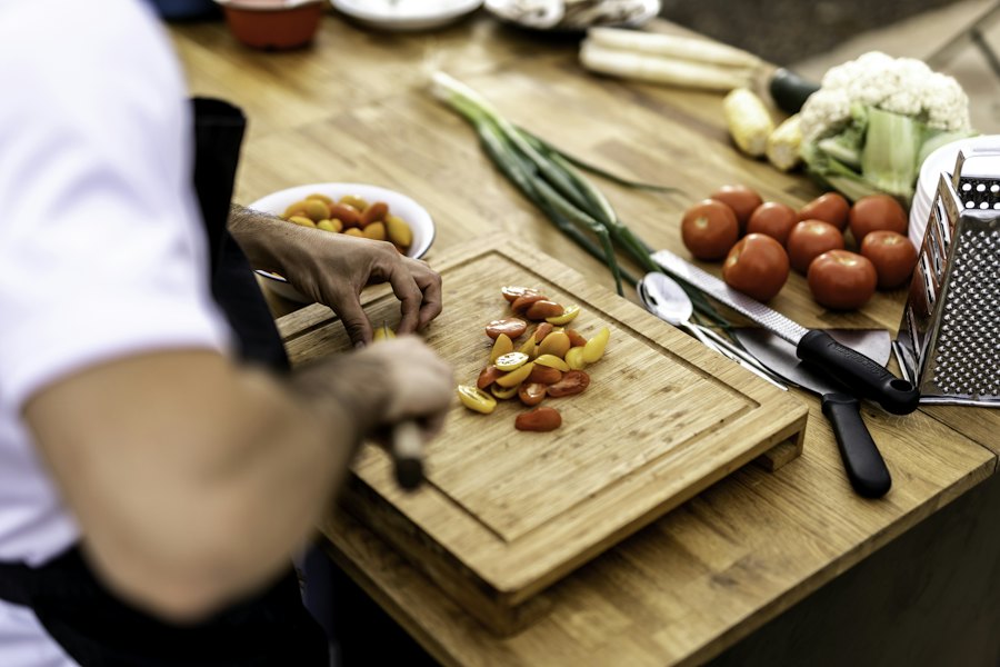Tomatoes and fresh herbs being chopped on a board