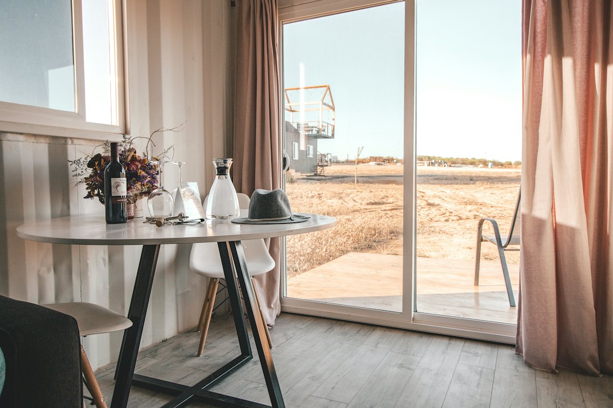 A room with tall windows opening onto a terrace