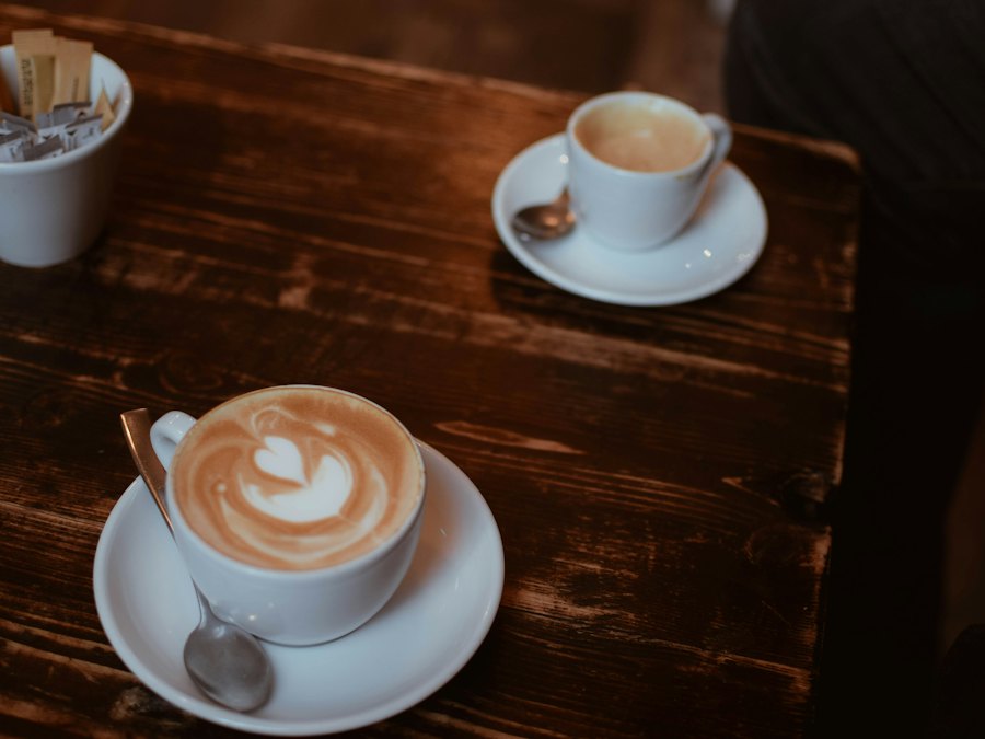Ahşap masa üzerinde latte art yapılmış bir fincan kahve