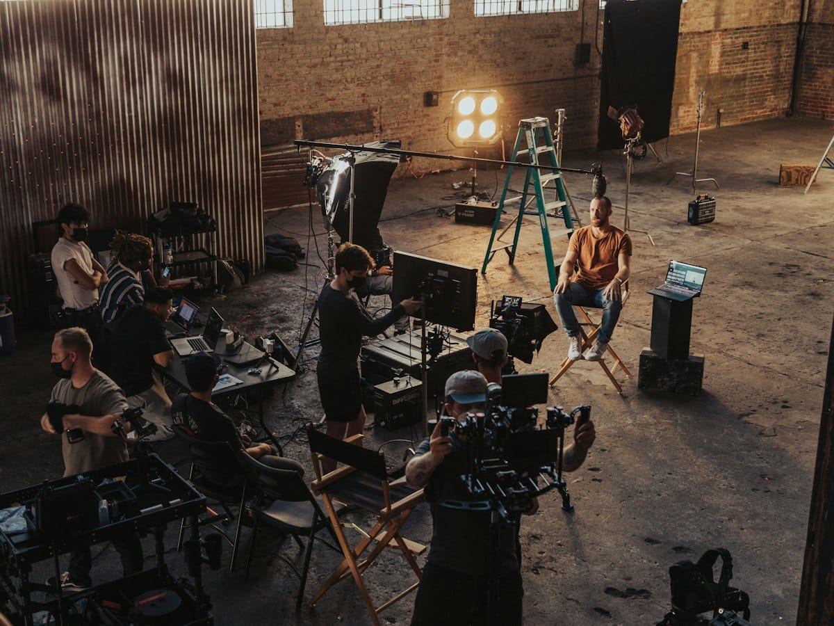 A production crew filming a commercial in a large studio