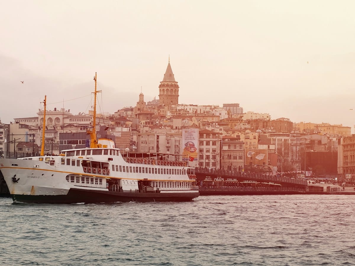 A passenger ferry crossing the water at sunset