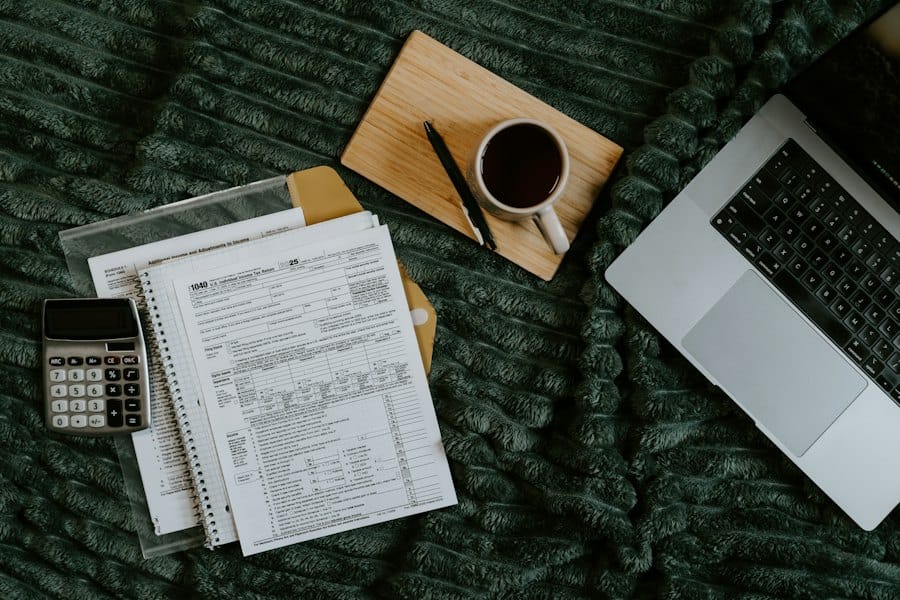A desk with a laptop, a coffee and printed media reports