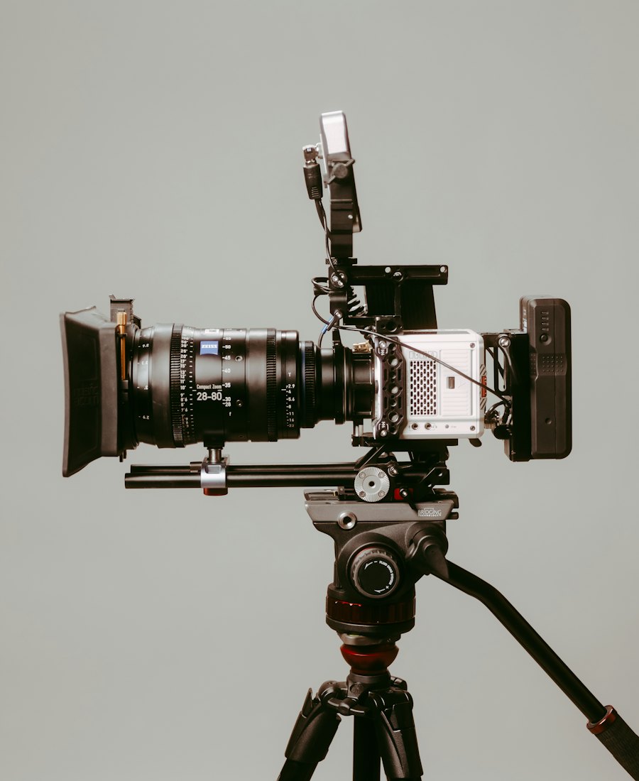 A cinema camera body with a lens, mounted on a tripod